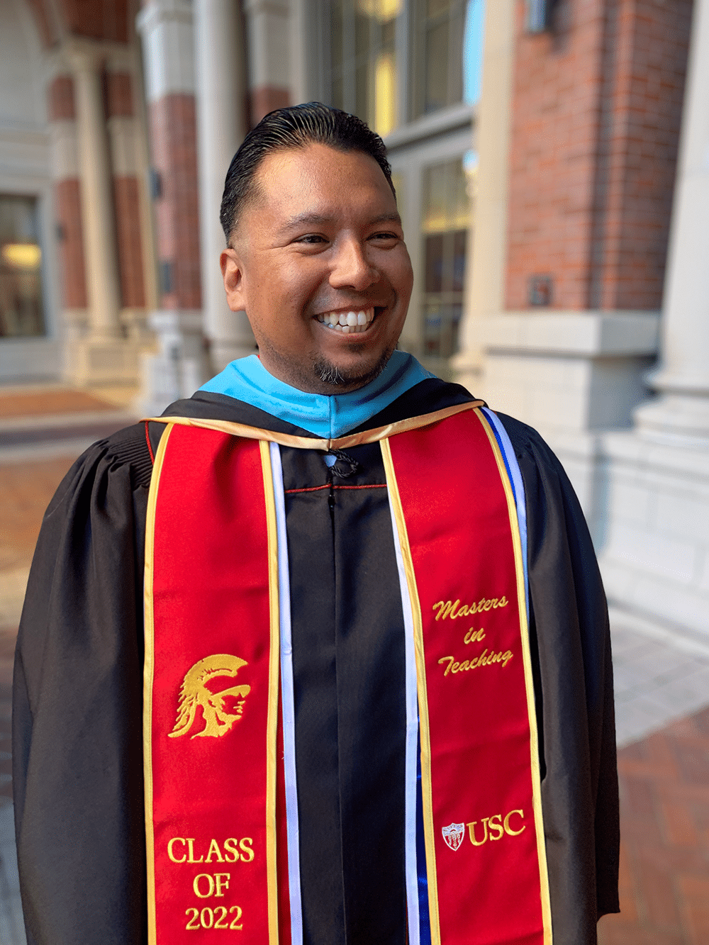 Gerardo wearing USC graduation gown.