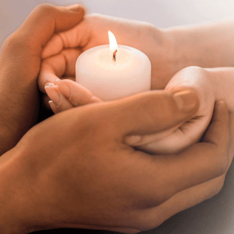 Day Of Remembrance Hands With Candle Cropped